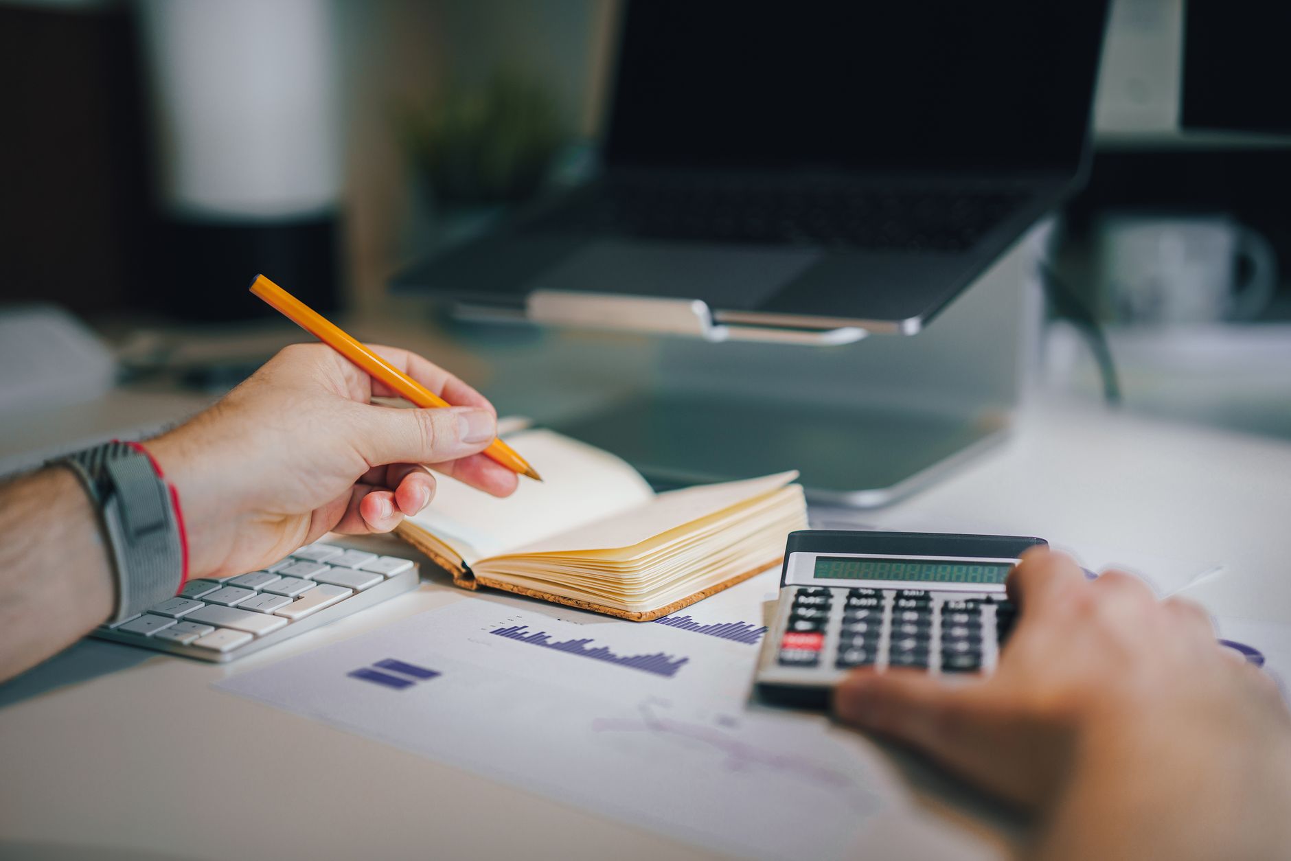 A business Professional working with calculator and laptop